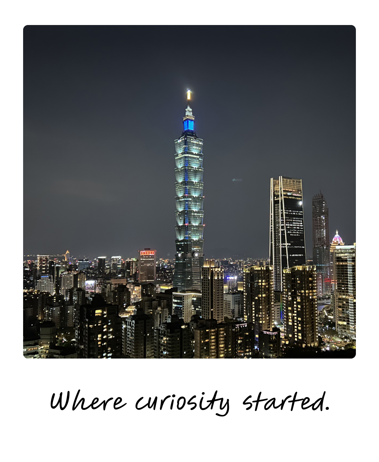 Taipei 101 lit up over the city skyline at night — where curiosity started.